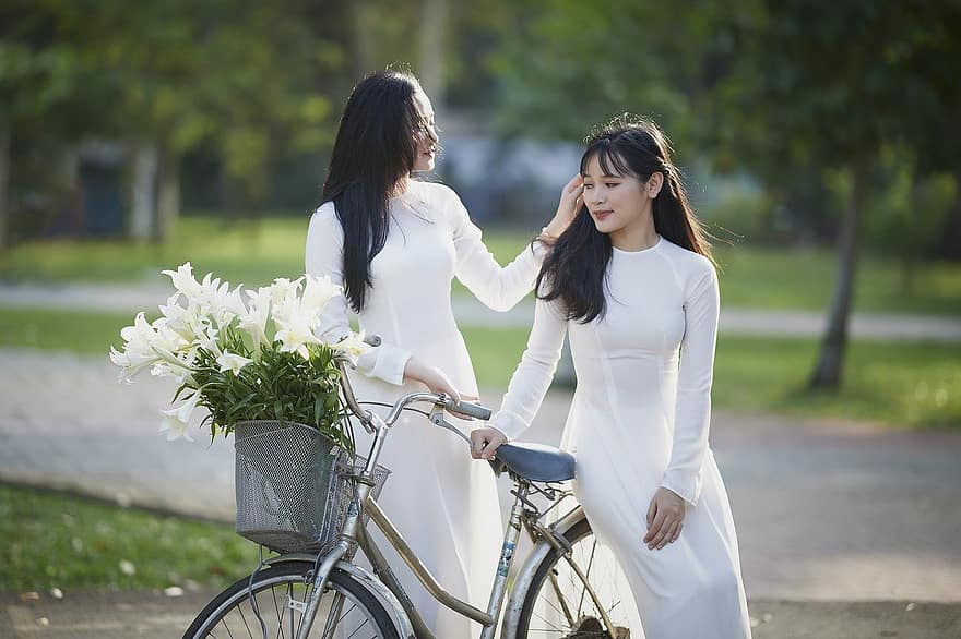 women, fashion, model, smiling, lifestyles, two people, bicycle, happiness, young adult, adult, cheerful