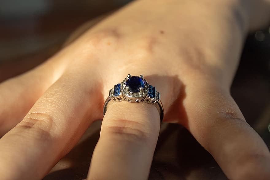 Jewelry, Ring, Sapphire, Accessory, Love, close-up, gemstone, human hand, gold, precious gem, shiny